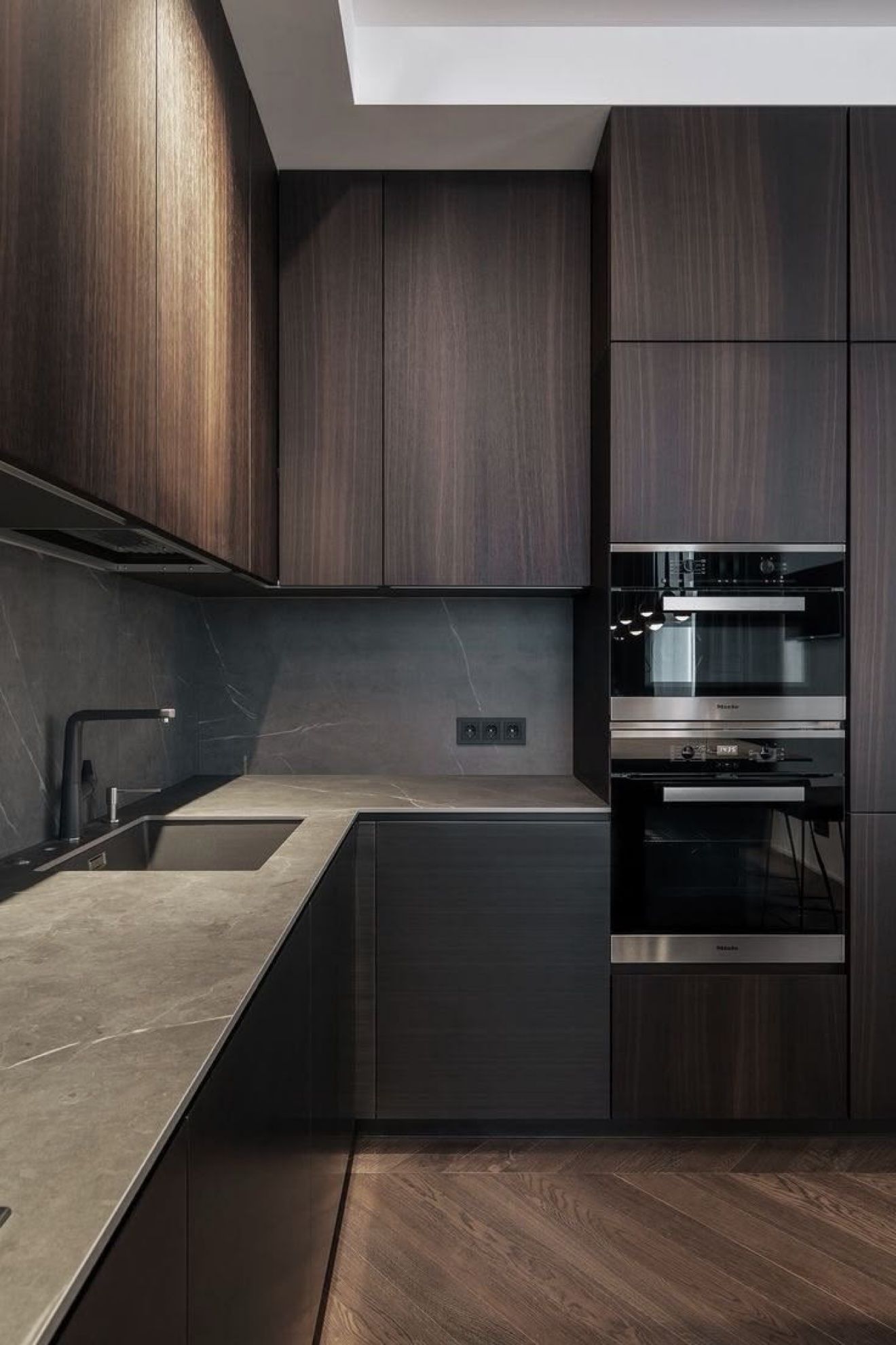 Dark walnut kitchen design with built-in ovens