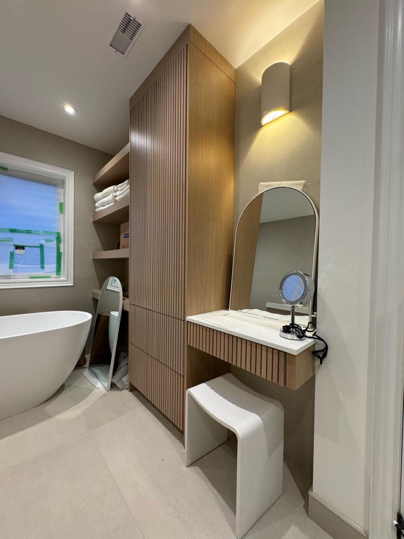 Bathroom vanity nook with fluted oak tower cabinet and makeup desk