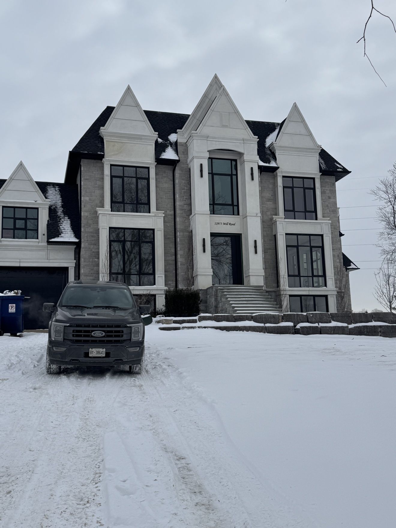 Custom luxury home exterior in winter, whole-home millwork project
