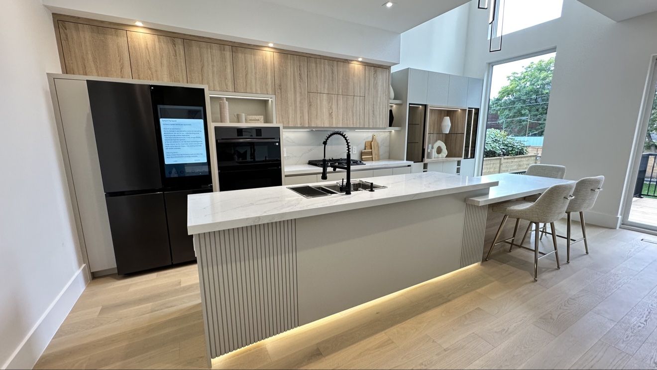 Custom kitchen with smart fridge and fluted island details
