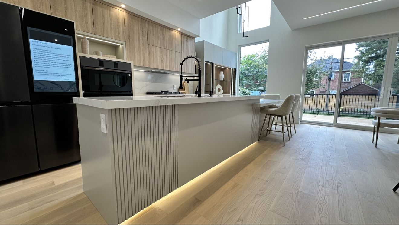 Kitchen island with hidden toe-kick lighting and fluted panels