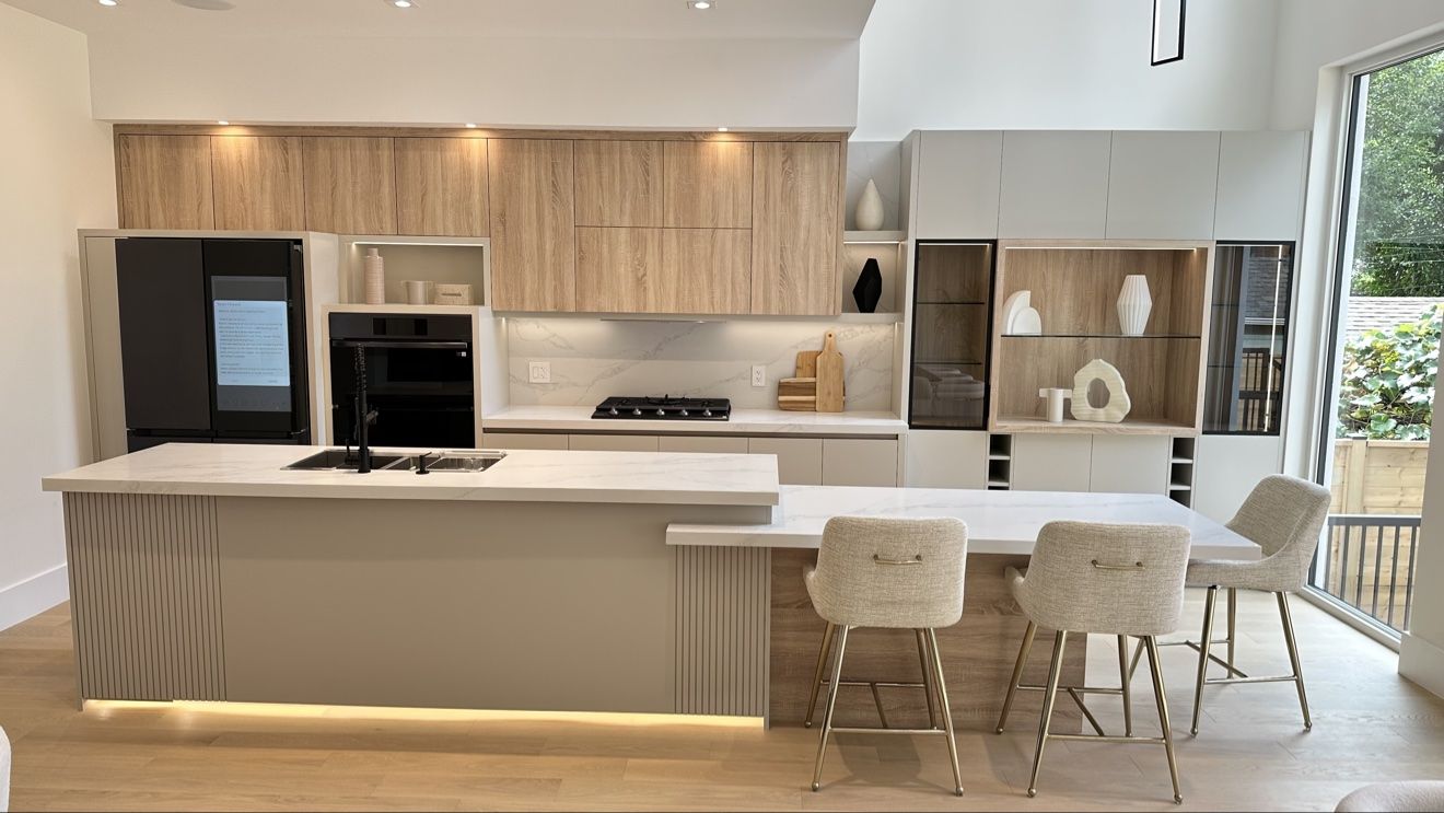 Light oak custom kitchen with fluted island and toe-kick lighting