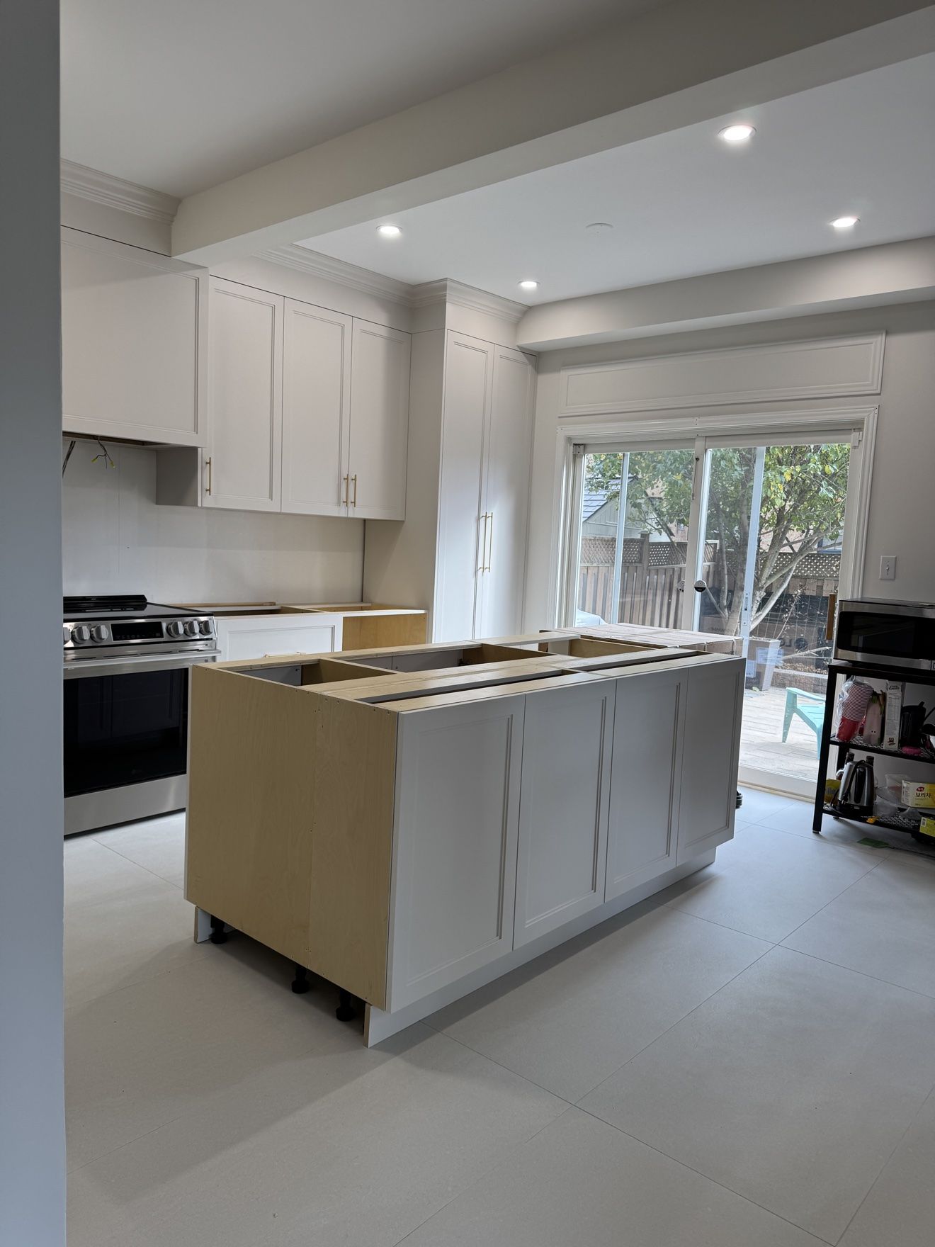 White shaker kitchen during installation, island in place