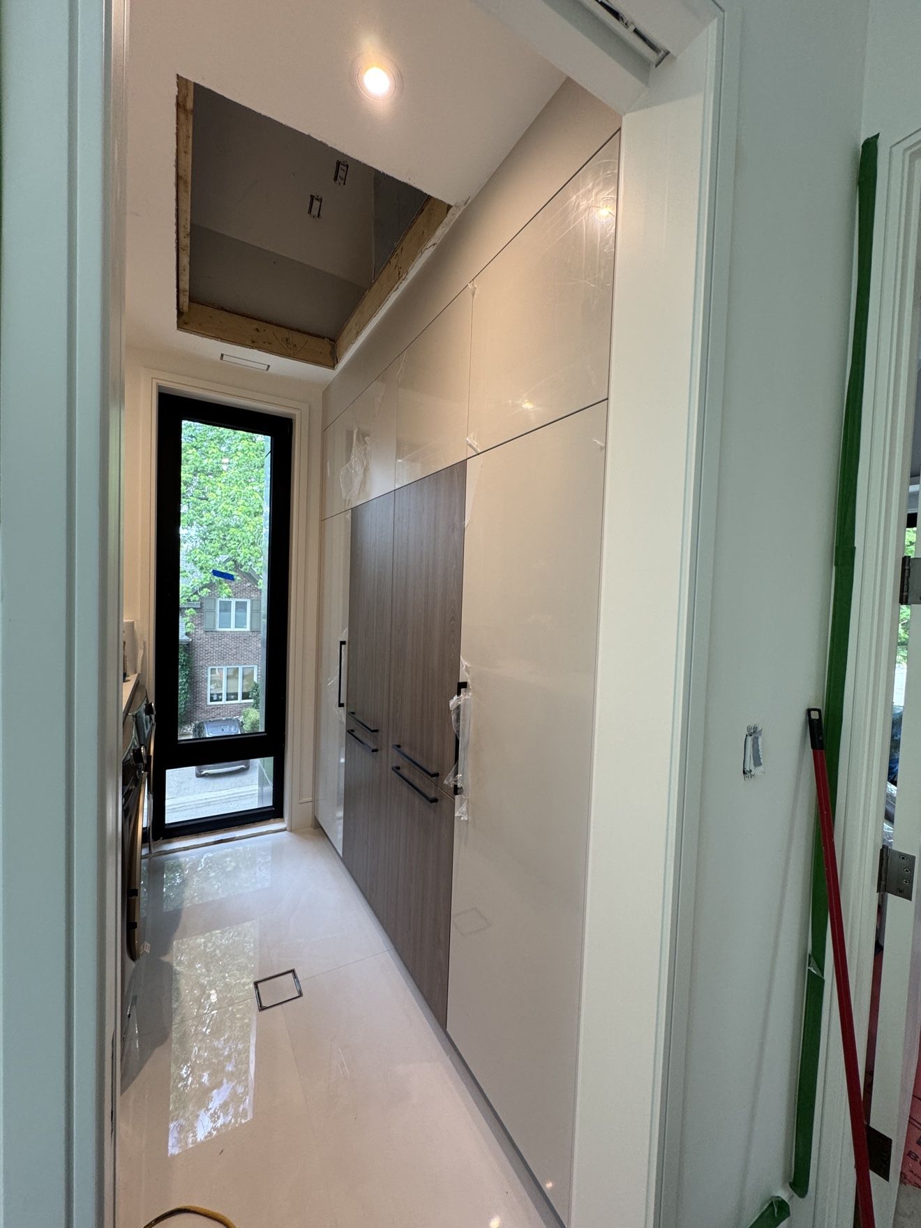 Laundry room built-ins with panelled appliances, during installation