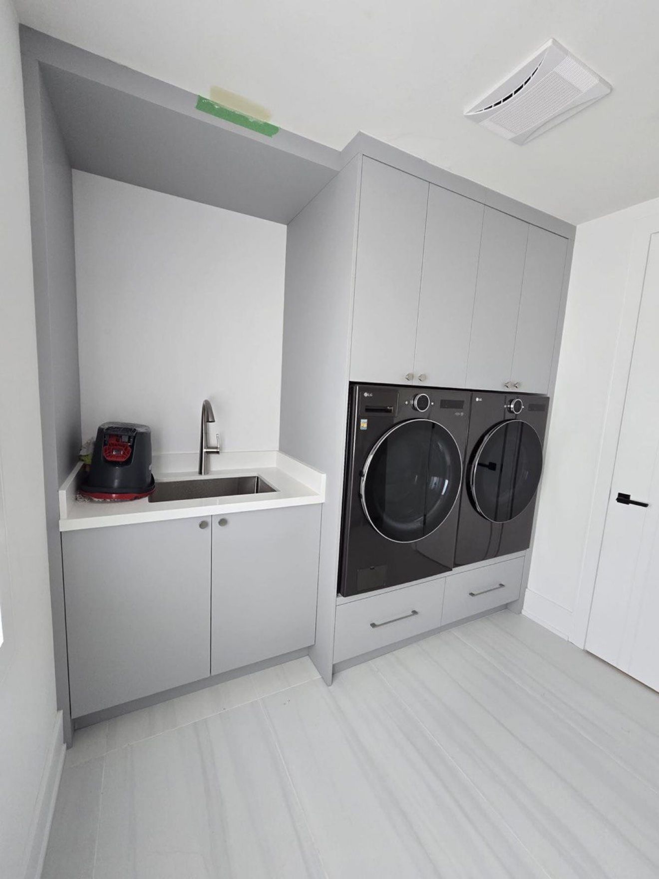 Laundry room with built-in washer and dryer surround and sink cabinet