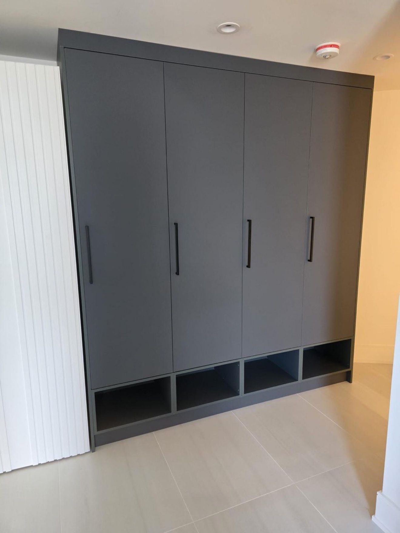 Dark grey entry lockers with open shoe cubbies