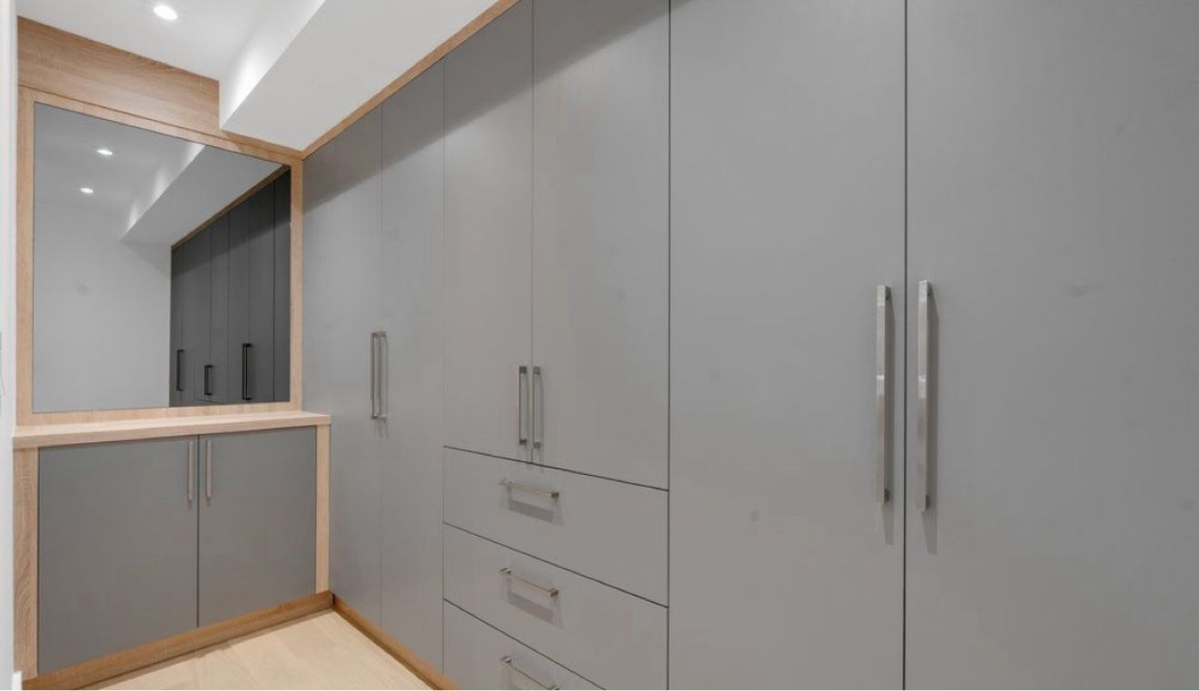 Grey custom wardrobe wall with mirror vanity