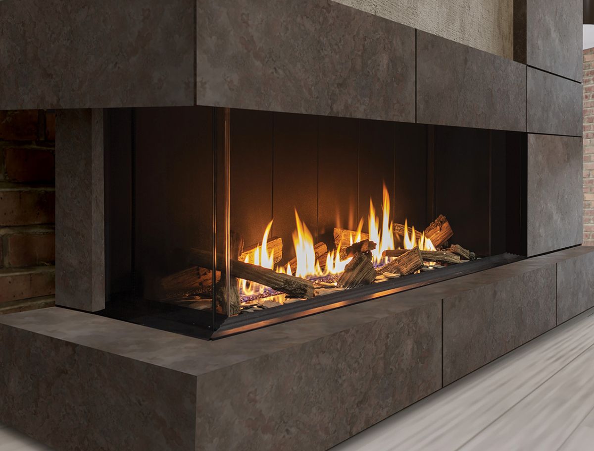 Urbana U50 Tall — tall corner gas fireplace with deep log flame in a stone surround